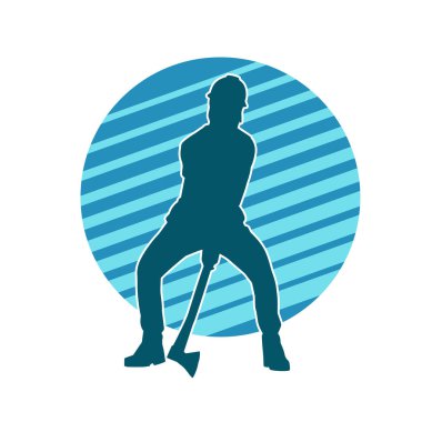 Hareket halindeki bir işçinin silueti, baltasını kullanarak poz verir..