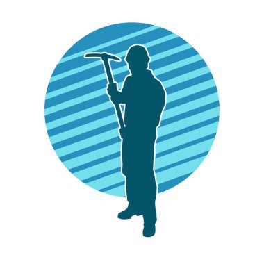 Görev sırasında baltayla dolaşan işçi kostümlü bir adamın silüeti. Bir madencinin hareket halindeki silueti balta aracı ile poz verir.