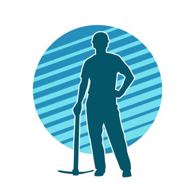 Görev sırasında baltayla dolaşan işçi kostümlü bir adamın silüeti. Bir madencinin hareket halindeki silueti balta aracı ile poz verir.