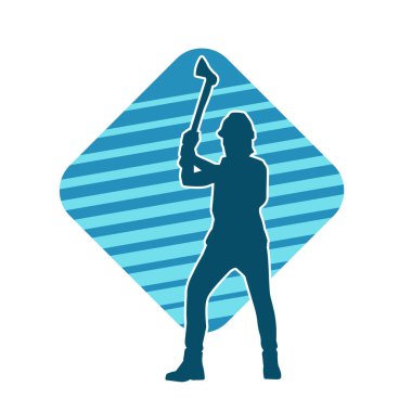 Hareket halindeki bir işçinin silueti, baltasını kullanarak poz verir..