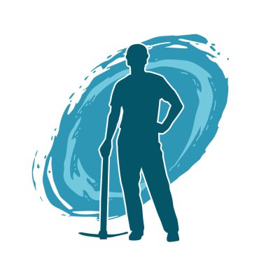 Görev sırasında baltayla dolaşan işçi kostümlü bir adamın silüeti. Bir madencinin hareket halindeki silueti balta aracı ile poz verir.