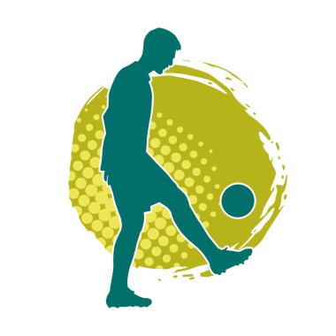 Top tekmeleyen bir erkek futbolcunun silueti. Hareket halindeki bir futbolcunun silueti.