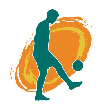 Top tekmeleyen bir erkek futbolcunun silueti. Hareket halindeki bir futbolcunun silueti.