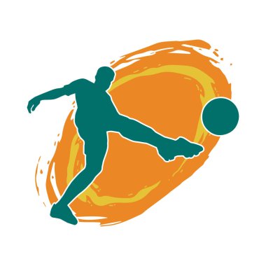 Top tekmeleyen bir erkek futbolcunun silueti. Hareket halindeki bir futbolcunun silueti.