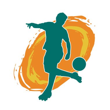 Top tekmeleyen bir erkek futbolcunun silueti. Hareket halindeki bir futbolcunun silueti.