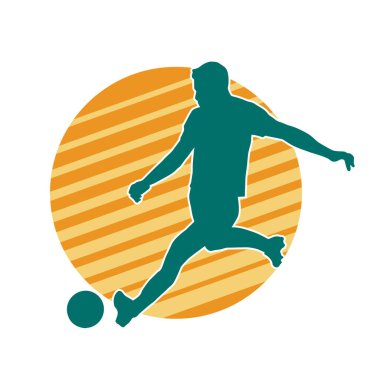 Top tekmeleyen bir erkek futbolcunun silueti. Hareket halindeki bir futbolcunun silueti.