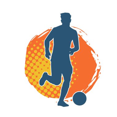 Top tekmeleyen bir erkek futbolcunun silueti. Hareket halindeki bir futbolcunun silueti.