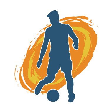 Top tekmeleyen bir erkek futbolcunun silueti. Hareket halindeki bir futbolcunun silueti.