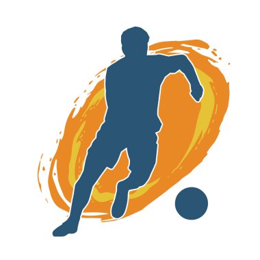 Top tekmeleyen bir erkek futbolcunun silueti. Hareket halindeki bir futbolcunun silueti.