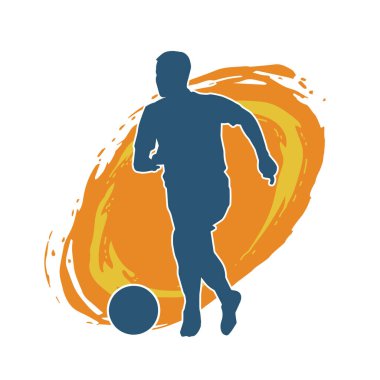 Top tekmeleyen bir erkek futbolcunun silueti. Hareket halindeki bir futbolcunun silueti.