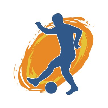Top tekmeleyen bir erkek futbolcunun silueti. Hareket halindeki bir futbolcunun silueti.