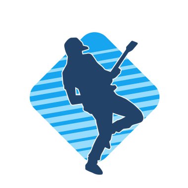 Elektro gitar çalan bir müzisyenin silueti. Bir erkek gitaristin silueti.