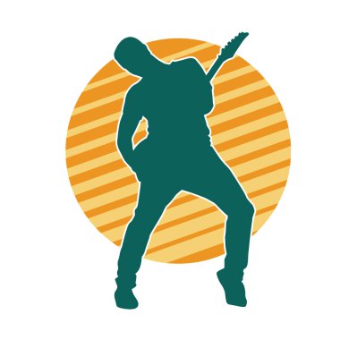 Elektro gitar çalan bir müzisyenin silueti. Bir erkek gitaristin silueti.