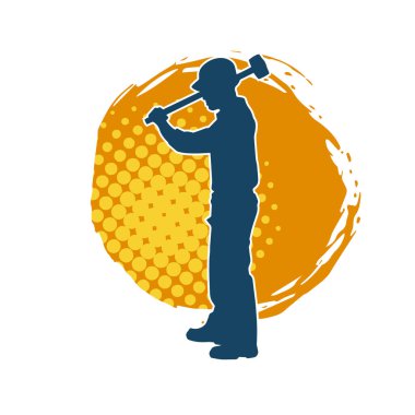 Çalışan bir işçinin silueti balyoz aletini kullanarak hareket halinde poz verir.