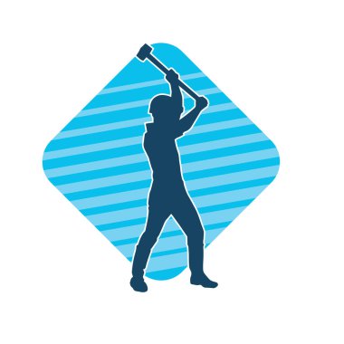 Çalışan bir işçinin silueti balyoz aletini kullanarak hareket halinde poz verir.