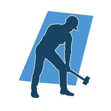 Çalışan bir işçinin silueti balyoz aletini kullanarak hareket halinde poz verir.