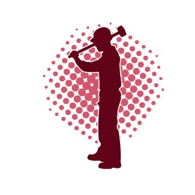 Çalışan bir işçinin silueti balyoz aletini kullanarak hareket halinde poz verir.