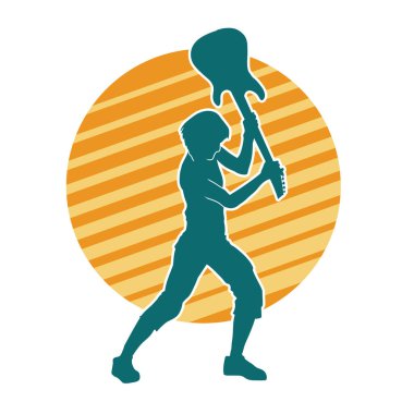 Elektro gitarı parçalayan bir rock müzisyeninin silueti..