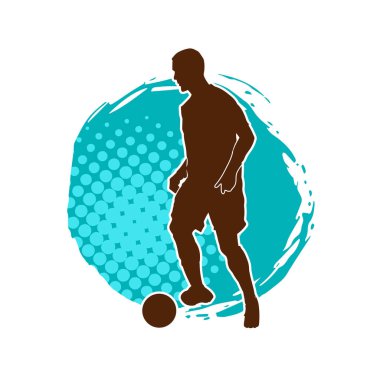 Top tekmeleyen bir erkek futbolcunun silueti. Hareket halindeki bir futbolcunun silueti.