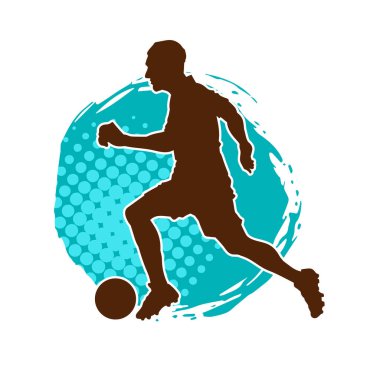 Top tekmeleyen bir erkek futbolcunun silueti. Hareket halindeki bir futbolcunun silueti.