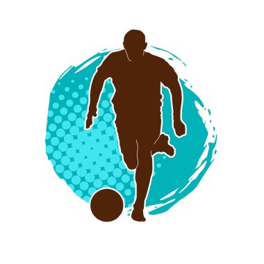 Top tekmeleyen bir erkek futbolcunun silueti. Hareket halindeki bir futbolcunun silueti.