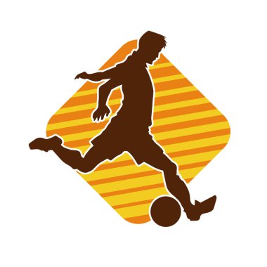 Top tekmeleyen bir erkek futbolcunun silueti. Hareket halindeki bir futbolcunun silueti.