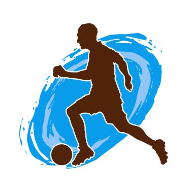 Top tekmeleyen bir erkek futbolcunun silueti. Hareket halindeki bir futbolcunun silueti.