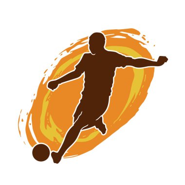 Top tekmeleyen bir erkek futbolcunun silueti. Hareket halindeki bir futbolcunun silueti.