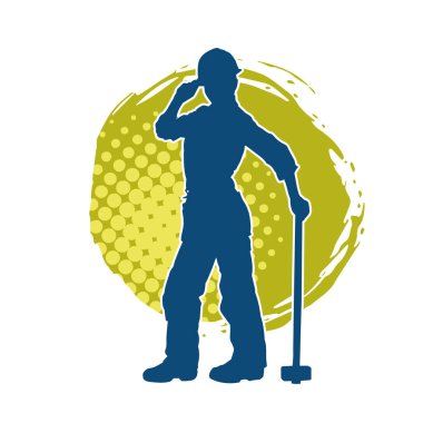 Çalışan bir işçinin silueti balyoz aletini kullanarak hareket halinde poz verir.