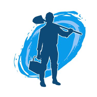 Kürek taşıyan bir işçinin silüeti. Bir işçinin hareket halindeki silueti kürek aracı kullanarak poz verir.