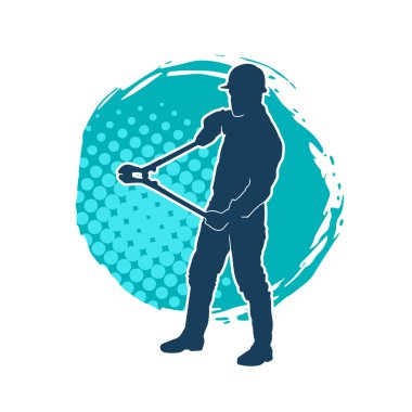 Bir erkek işçinin silueti hareket halindeyken büyük bir kerpeten ya da cıvata kesici aletle poz verir