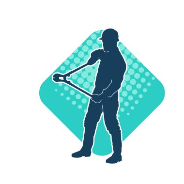 Bir erkek işçinin silueti hareket halindeyken büyük bir kerpeten ya da cıvata kesici aletle poz verir