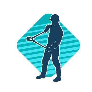 Bir erkek işçinin silueti hareket halindeyken büyük bir kerpeten ya da cıvata kesici aletle poz verir