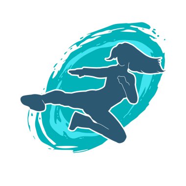 Dövüş sanatları tekmesi atan bir kadının silueti. Sportif bir kadının silueti tekme hareketi yapıyor..