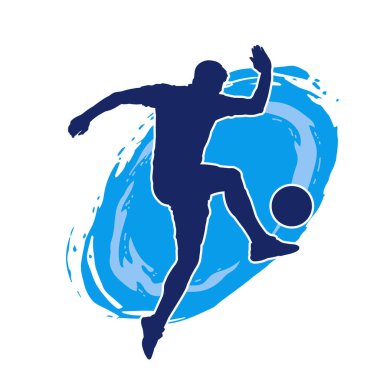 Top tekmeleyen bir erkek futbolcunun silueti. Hareket halindeki bir futbolcunun silueti.