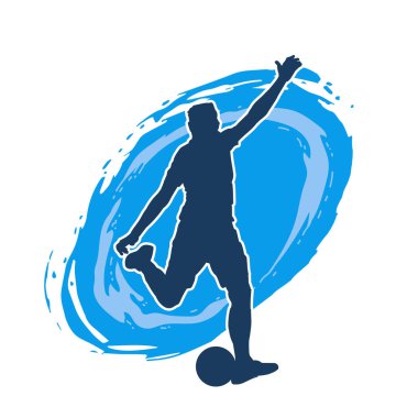 Top tekmeleyen bir erkek futbolcunun silueti. Hareket halindeki bir futbolcunun silueti.