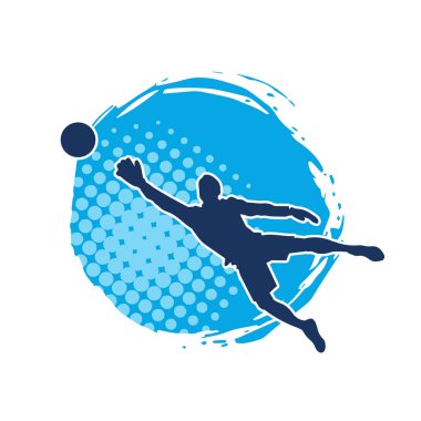 Erkek bir futbol kalecisinin silueti zıplayarak topa yaklaşıyor.
