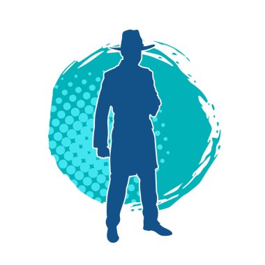 Uzun paltolu ve kovboy şapkalı bir adamın silueti.