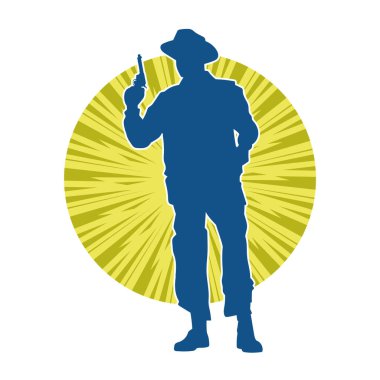 Kovboy kostümü giymiş bir adamın silüeti. Tabanca tabancası taşıyormuş gibi poz veriyor.