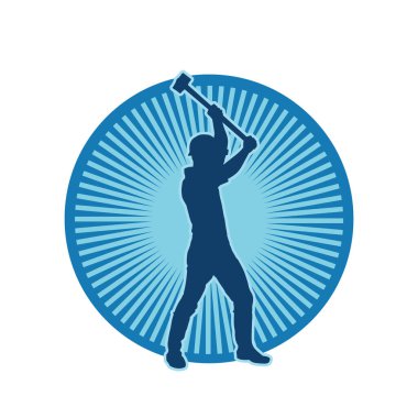 Çalışan bir işçinin silueti balyoz aletini kullanarak hareket halinde poz verir.