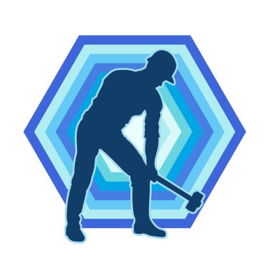 Çalışan bir işçinin silueti balyoz aletini kullanarak hareket halinde poz verir.