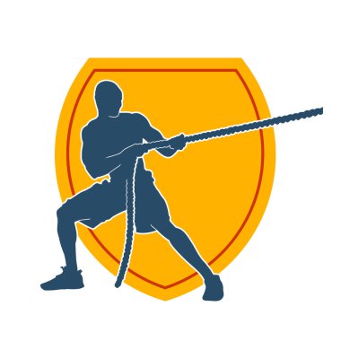 Sportif bir adamın silueti savaş halatıyla egzersiz yapıyor. 