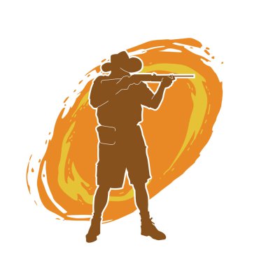 Safari kostümü giymiş, kovboy şapkası takmış tüfeğiyle ateş eden bir avcının silueti. Kovboy kıyafetli bir adamın silueti uzun namlulu silahıyla ateş ediyor..