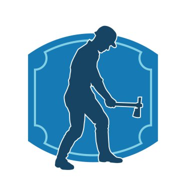 Hareket halindeki bir işçinin silueti, baltasını kullanarak poz verir..