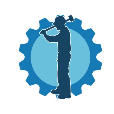 Çalışan bir işçinin silueti balyoz aletini kullanarak hareket halinde poz verir.