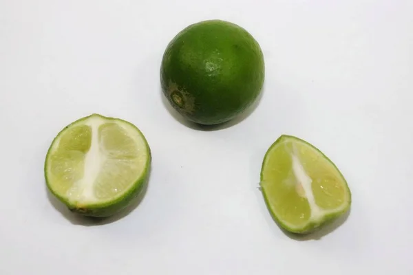 Limes Green Some Have Been Split Gray Background — Stock Photo, Image