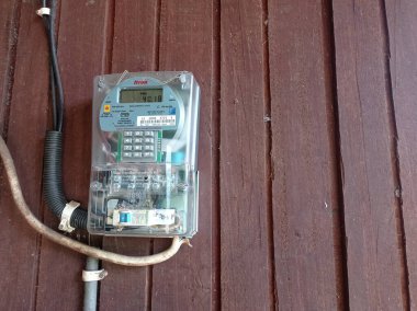 Batı Kutai, Doğu Kalimantan, Endonezya - 08 Ekim 2022 - bir makbuzla doldurulmuş bir elektrik sayacı