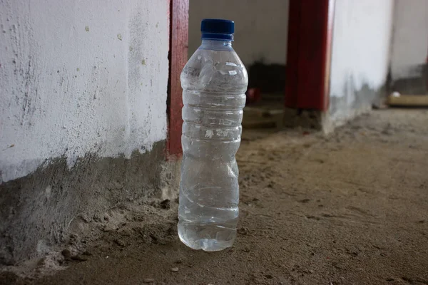 a plastic mineral water bottle placed on the floor