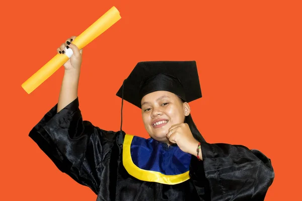 Portrait of happy and excited asian student girl in graduation cap, Studying, education, university, college, graduate concept. orange banner