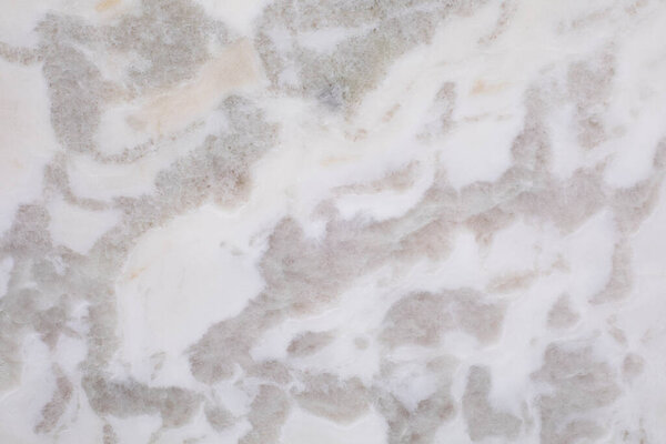 Close view of quartzite stone pattern in white, gray , taupe and beige. Full freamr for a backdrop.